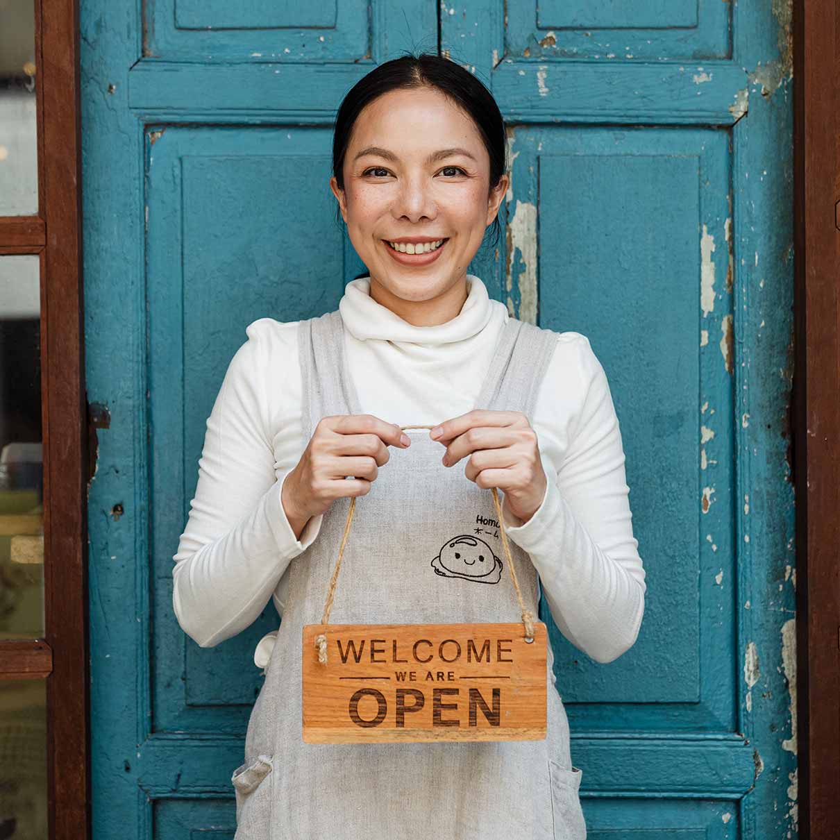 Woman Holding Welcome Sign Woman Holding Welcome Sign